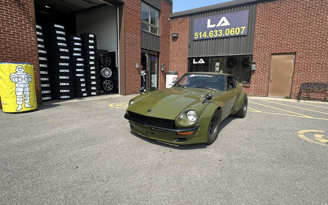 Front of the L.A Tires garage, with stacked tires visible in the open bay.